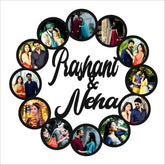 A wooden round wall photo frame with multiple circular cut-outs, each holding a photograph of different people, arranged in a spiral pattern with the names 'Rashmi & Neha' written in the center.